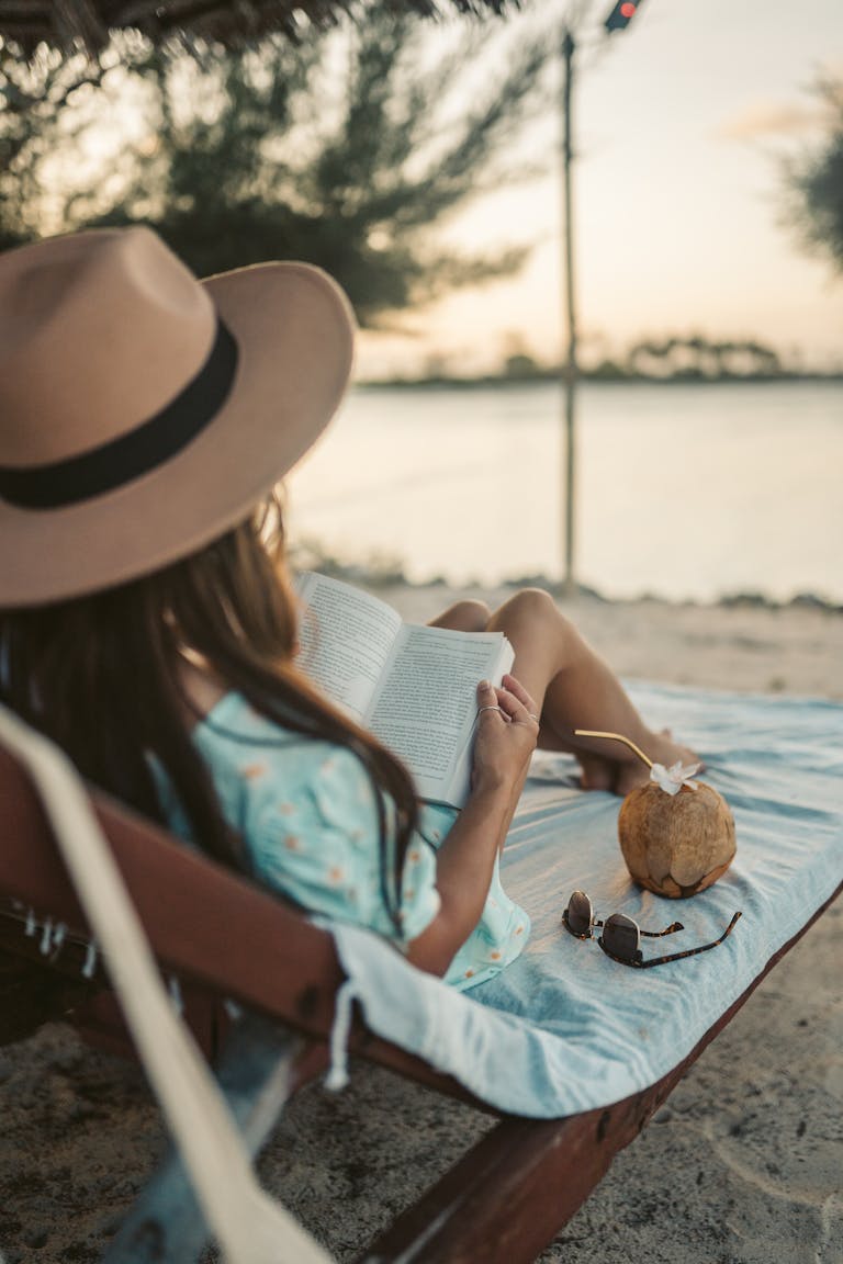 Woman reading on a beach in Zanzibar while enjoying the serene coastal view.