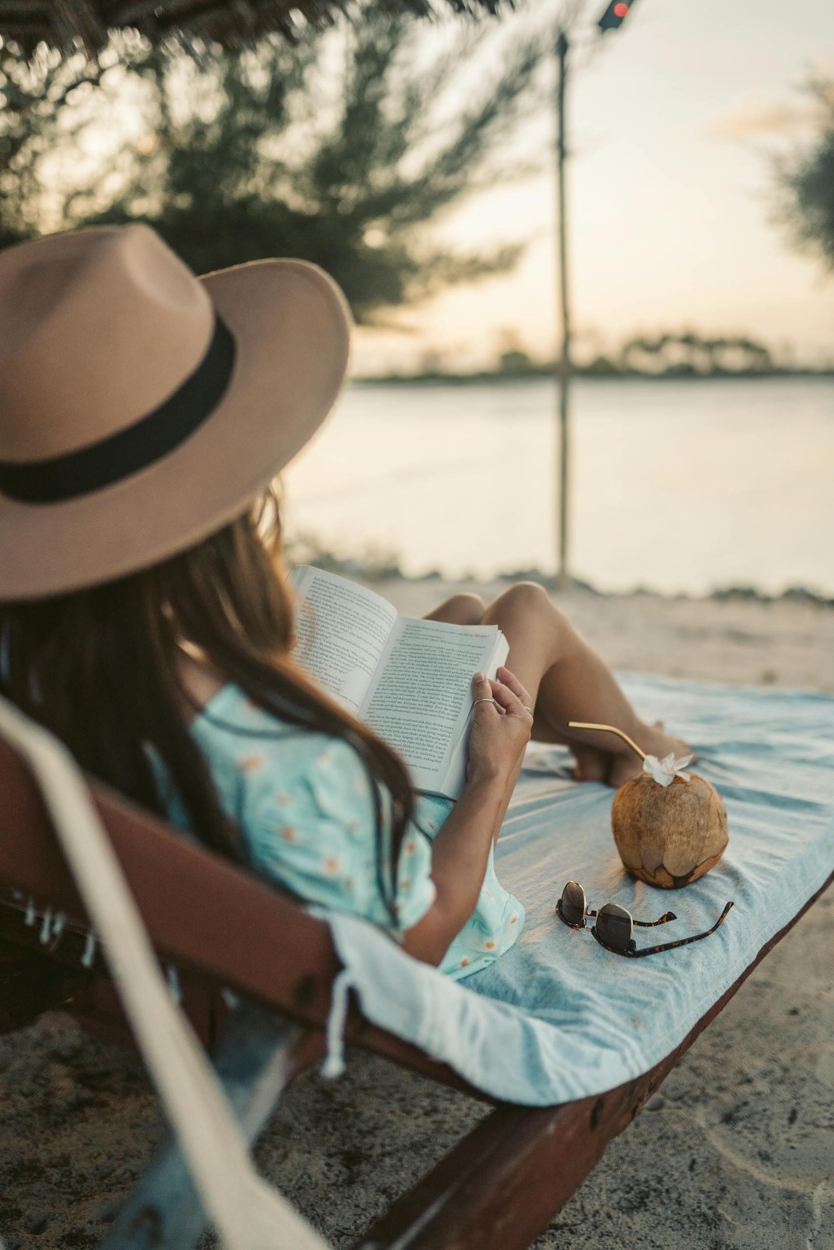 Woman reading on a beach in Zanzibar while enjoying the serene coastal view.
