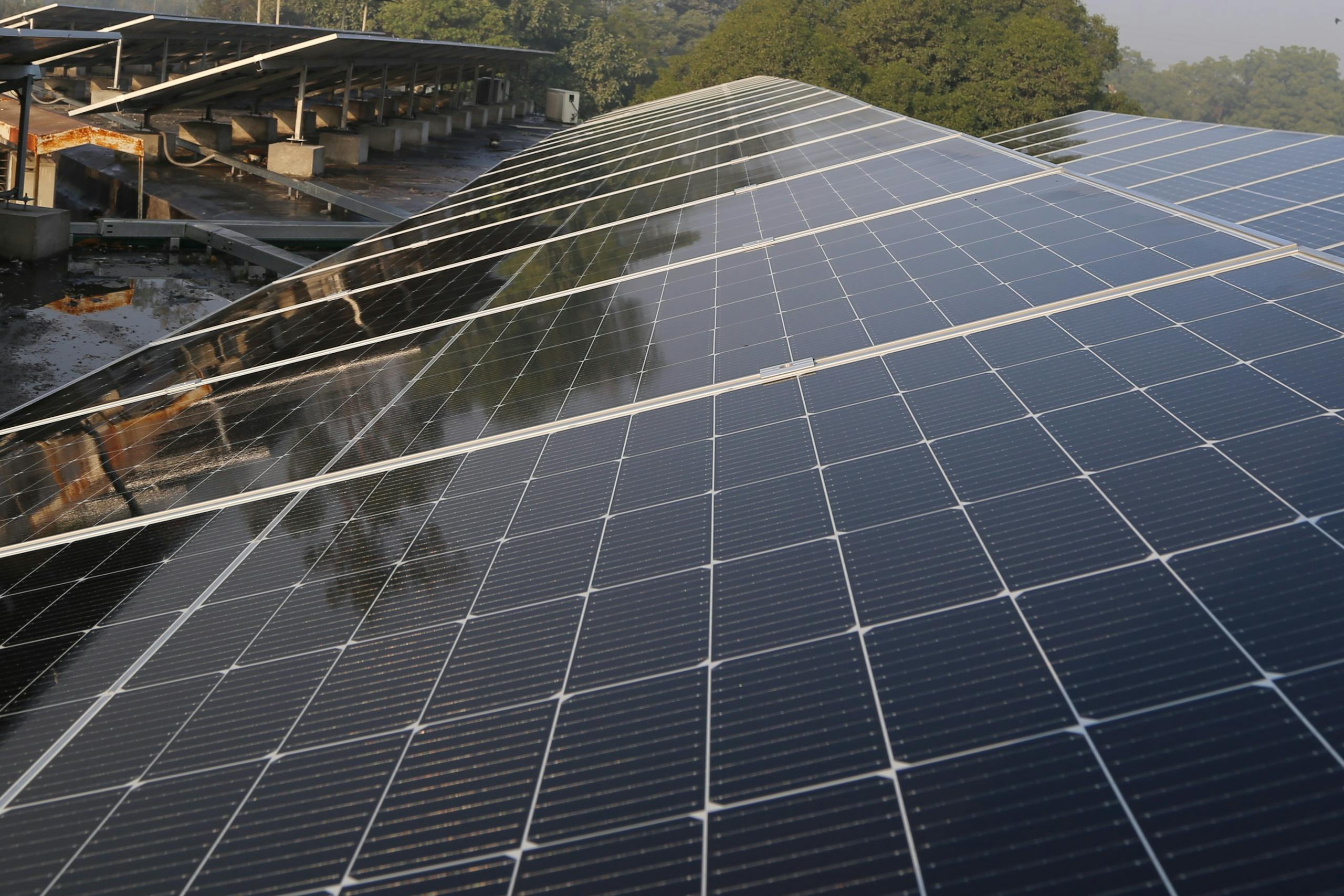 Wide view of solar panels on a rooftop in Lahore, promoting clean energy and sustainability.