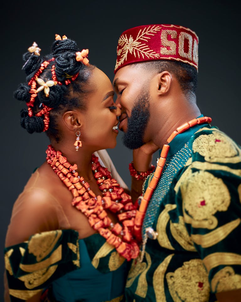 Close-up of a couple in colorful traditional attire sharing a tender moment.